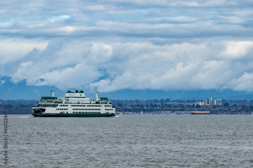 Washington State Ferry Travels Towards Mukilteo On a Cloudy Day With Everett Washington in Background