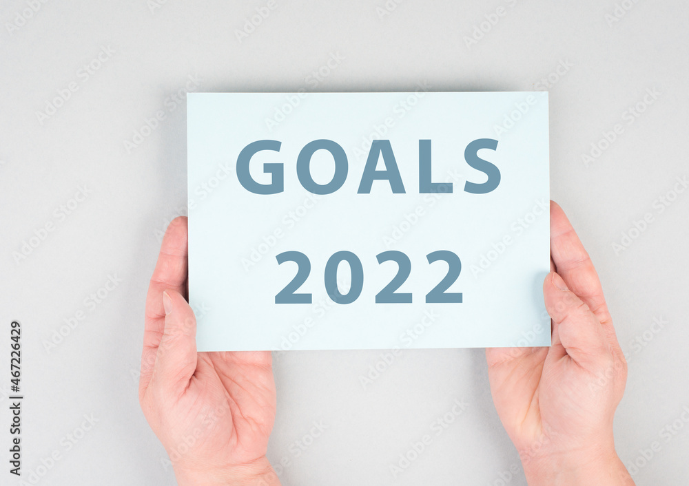 Goals 2022 is standing on a paper, hands are hold in the message, planning new achievements for the new year Goals 2022 is standing on a paper, hands are hold in the message, planning new achievements for the new year