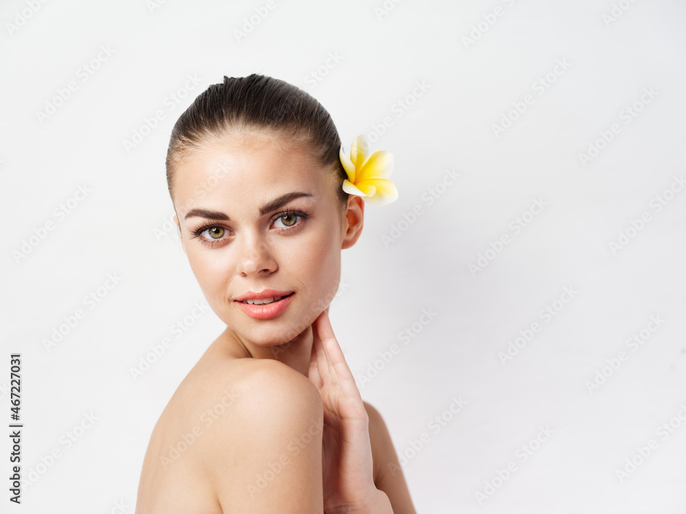 attractive women face makeup naked shoulders yellow flower in hair attractive women face makeup naked shoulders yellow flower in hair