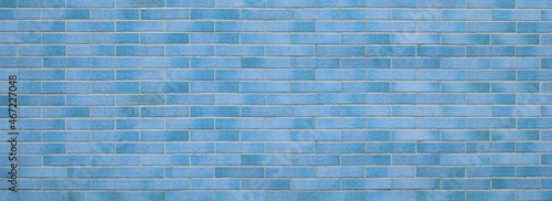 Textured blue background, empty copy space for text, brick wall structure, old cruny brickwork
