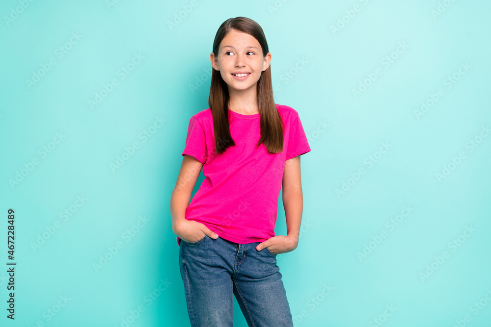 Portrait of attractive cheerful girl holding hands in pockets pondering isolated over bright teal turquoise color background Portrait of attractive cheerful girl holding hands in pockets pondering isolated over bright teal turquoise color background