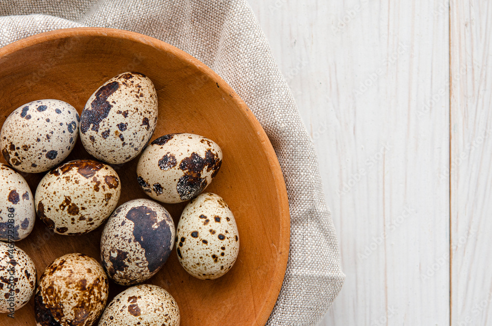 quail eggs in wooden plate over dark old wooden background quail eggs in wooden plate over dark old wooden background