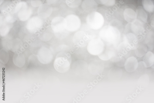 Grey and white abstract bokeh background. Ideal for use as a backdrop for digital product mockups with a Christmas, festive, new year or party theme.