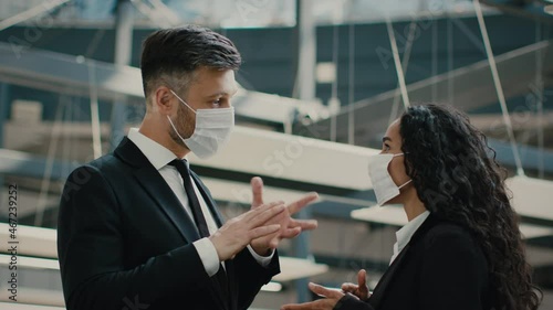 Two Colleagus Talking Wearing Face Masks Communicating In Modern Office photo