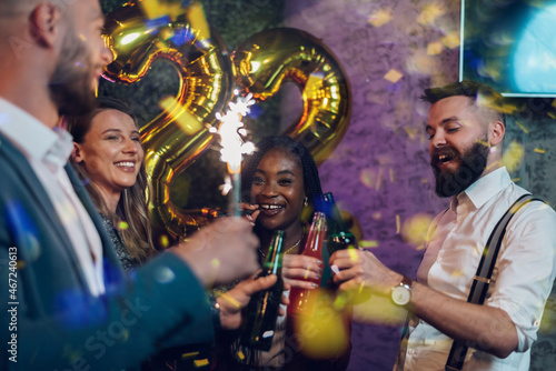 Happy group of friends celebrate New Year's Eve in a club