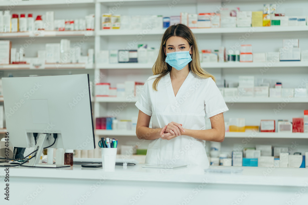 Pharmacist with protective mask on her face while working at a pharmacy
