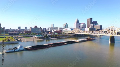 Aerial of Ohio River barge in front of city skyline of Louisville, Kentucky. photo