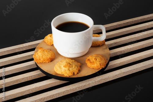 Cup of coffee with cookies on a wooden table