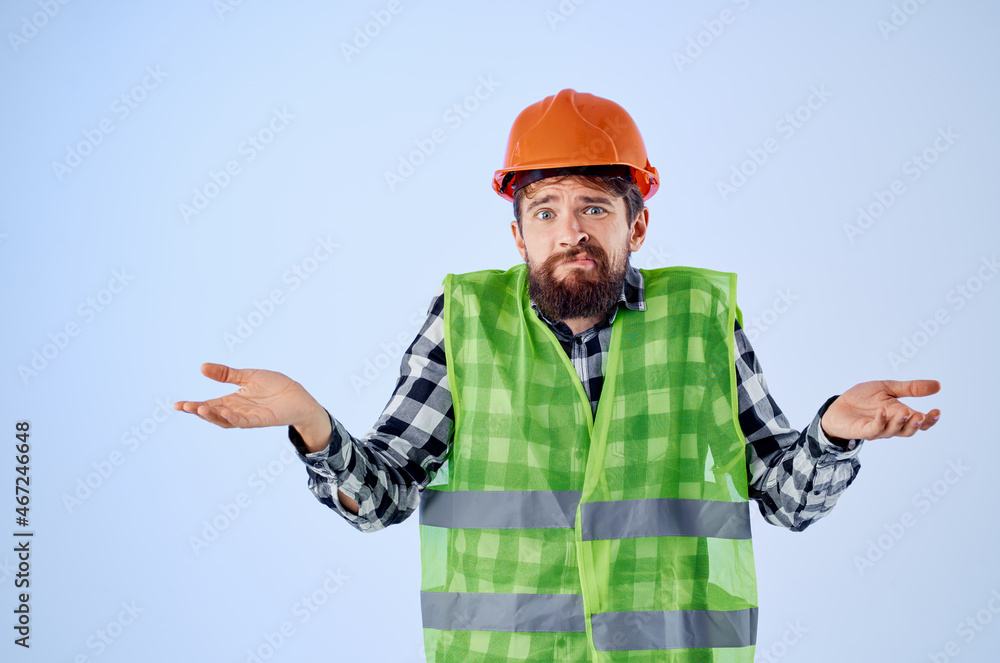 bearded man in orange hard hat construction professional blue background