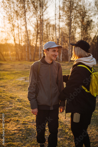 Cute young adult couple joking outdoors in the sunlight - portrait with selective focus