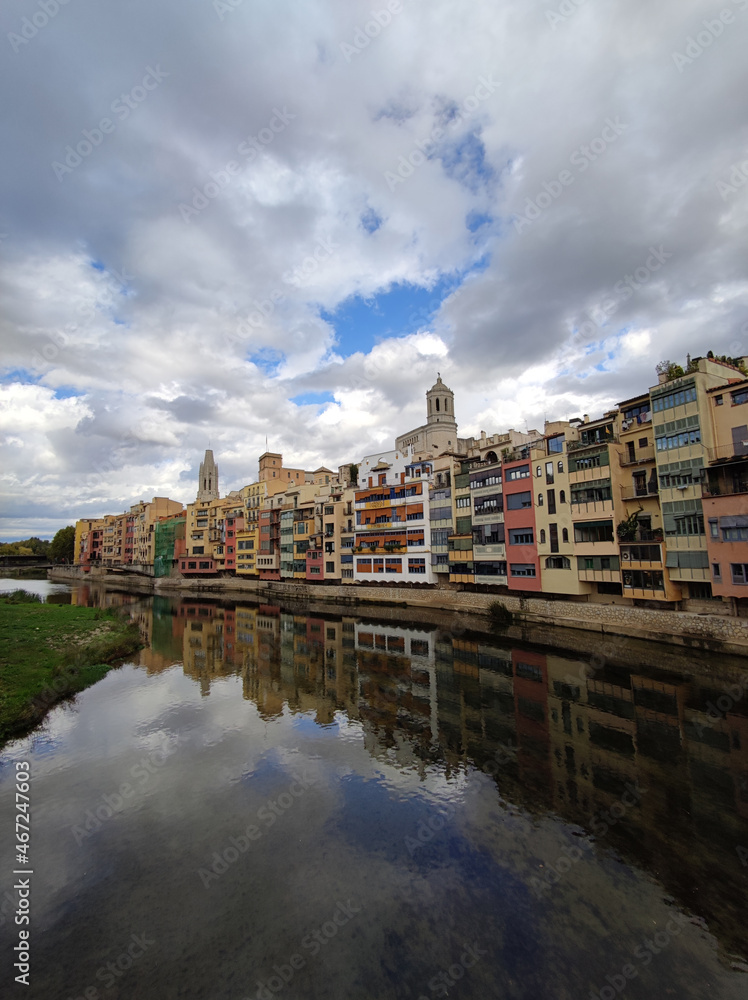 Colorful historical houses,facades, reflected in water of the river Onyar, in Girona, Catalonia, Spain.
