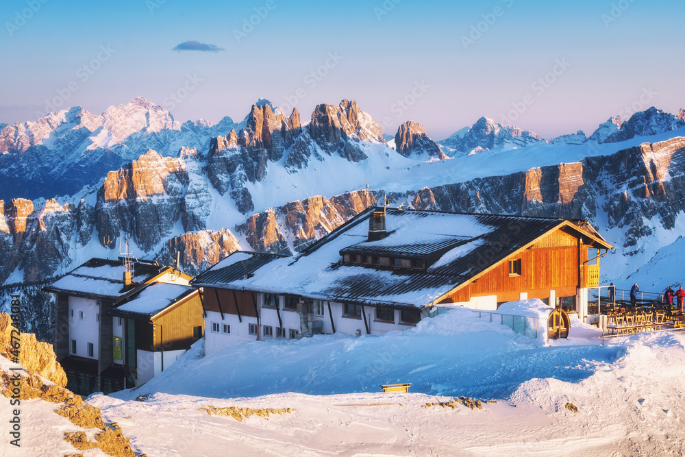 Rifugio Lagazuoi and the top station of the cable car against the background of the mountain sunset, Cortina Dolomites, Alps, Italy. Winter landscape in the mountains, Dolomiti Superski.