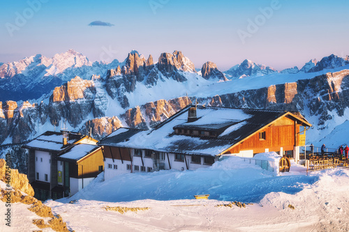 Obraz na płótnie Rifugio Lagazuoi and the top station of the cable car against the background of the mountain sunset, Cortina Dolomites, Alps, Italy. Winter landscape in the mountains, Dolomiti Superski. w salonie