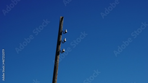 wireless electricity pole against sky background