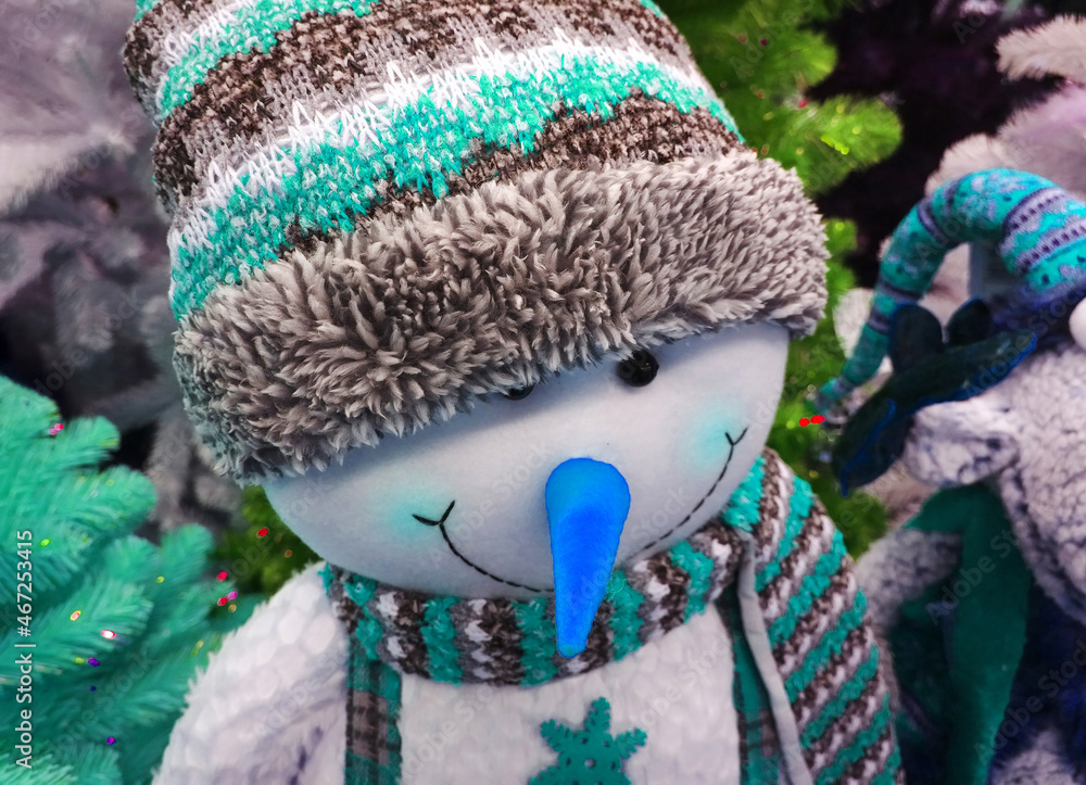 Soft funny cheerful smiling snowman in winter hat with blue nose. Crafters virtual Christmas fair. Cute handmade gift toy. Happy New Year. Xmas collection. Sewing doll for kids. Traditional festival.