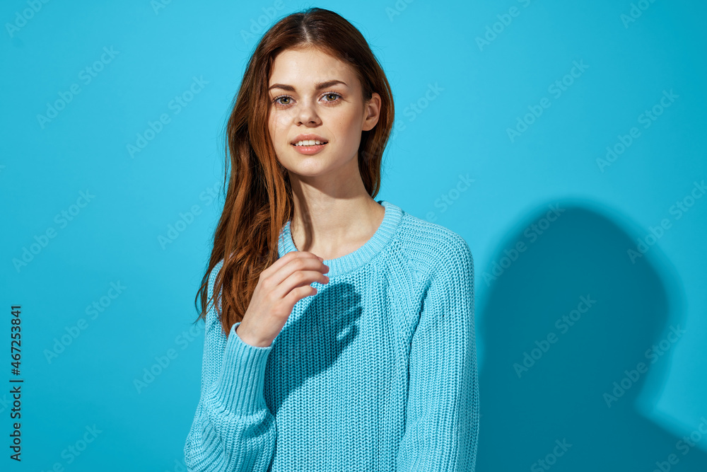 woman in a blue sweater blue background Lifestyle woman in a blue sweater blue background Lifestyle