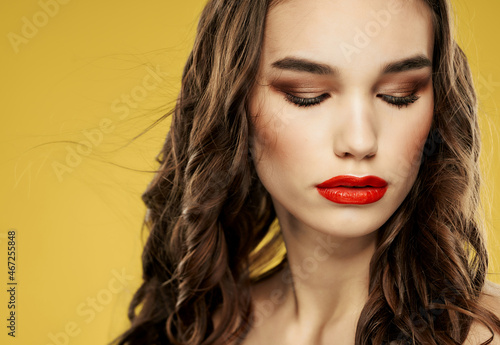woman with red lips hairstyle fashion close up yellow background