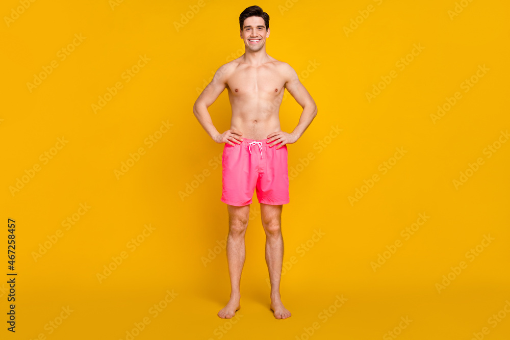 Full length body size view of attractive cheerful content guy sea rest isolated over bright yellow color background Full length body size view of attractive cheerful content guy sea rest isolated over bright yellow color background