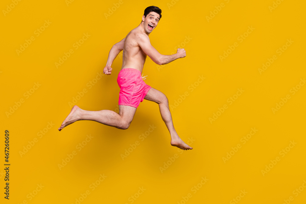 Full length profile side photo of young man happy positive smile go walk run jumper isolated over yellow color background