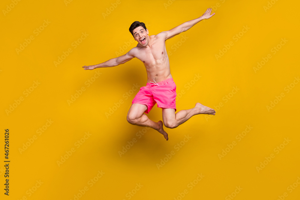 Full length body size view of attractive cheerful funny guy jumping diving having fun isolated over shine yellow color background