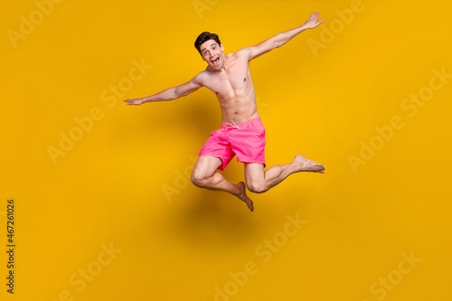 Full length body size view of attractive cheerful funny guy jumping diving having fun isolated over shine yellow color background © deagreez