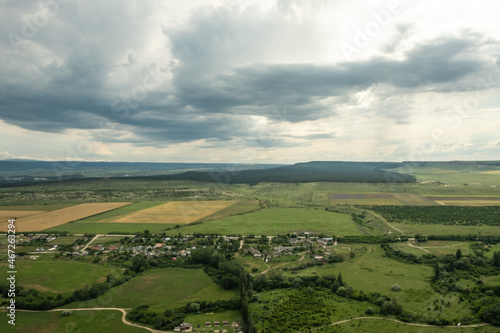 Panorama of the steppe landscape. View from the mountain to the surrounding area. Fields  roads  villages  mountains from a bird s eye view. Day. Summer