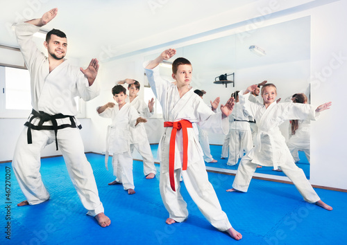 Children trying new martial moves in the practice during karate class