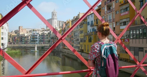 Woman Looking At Onyar River On The Middle Of Eiffel Bridge In Girona, Spain. wide shot, rear photo