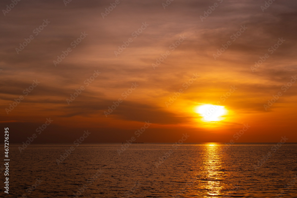 Sunset on the horizon, orange-red sea, nature at twilight, beautiful.