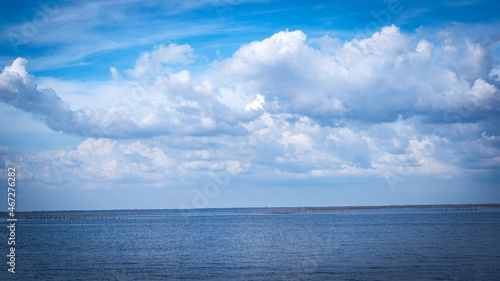 The vast sea with white clouds in the blue sky, beautiful nature.