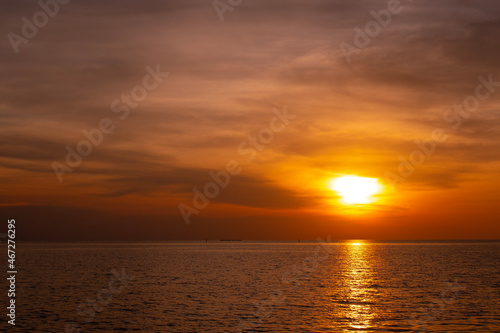 Sunset on the horizon, orange-red sea, nature at twilight, beautiful.
