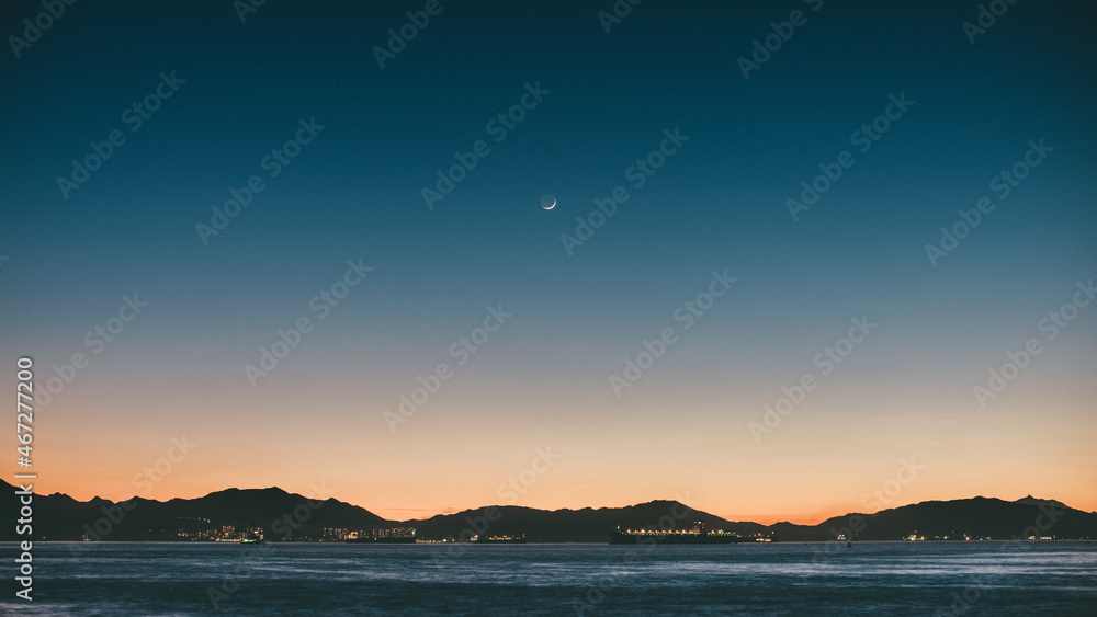 Sun glow with moon after sunset in Hong Kong Sun glow with moon after sunset in Hong Kong