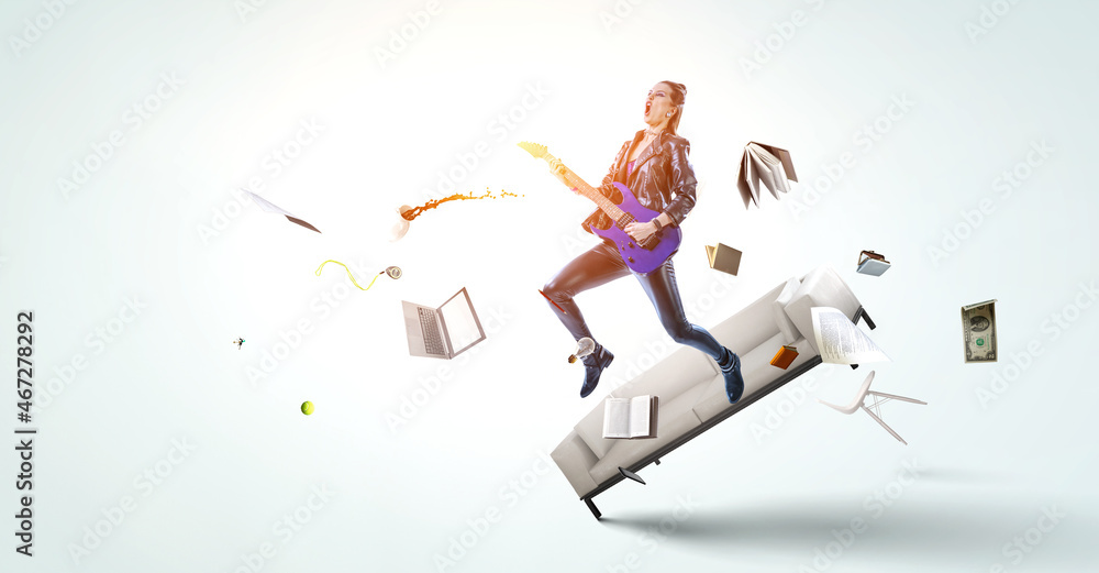 Young and beautiful rock girl playing the electric guitar . Mixed media