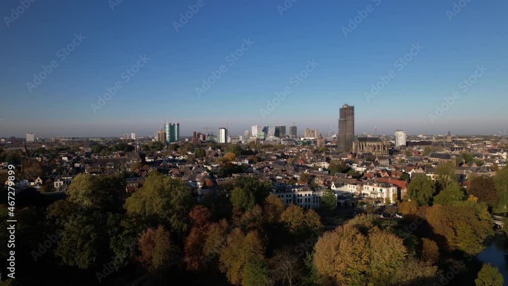 Autumn colors in the Lepelenburg park trees with the cityscape of Utrecht in the background where the scaffolded church tower rises above the urban Dutch city. Autumn colors in the Lepelenburg park trees with the cityscape of Utrecht in the background where the scaffolded church tower rises above the urban Dutch city.
