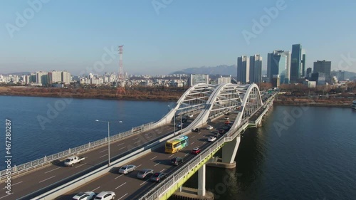 Traffic on the Yanghwa bridge in Seoul. 
Cars are moving on a arch bridge over a Han river at sunny day morning. Aerial view. South Korea.
서울 한강 양화대교. photo