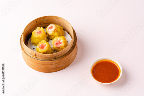 Top View of Assorted Chinese Dimsum in bamboo basket. Dimsum is a large range of small dishes that Cantonese people traditionally enjoy in restaurants for breakfast and lunch.