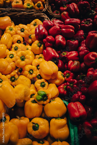 red and yellow peppers on display photo