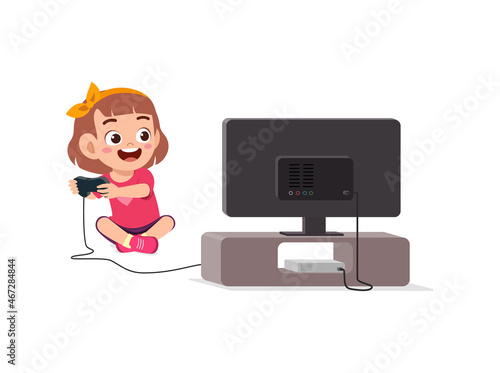 cute little girl play video game on big screen
