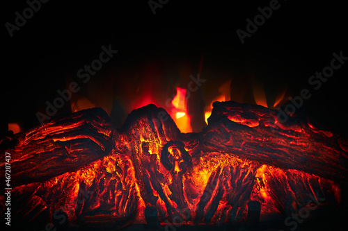 Artificial fireplace. Burning logs. Decorative fire.