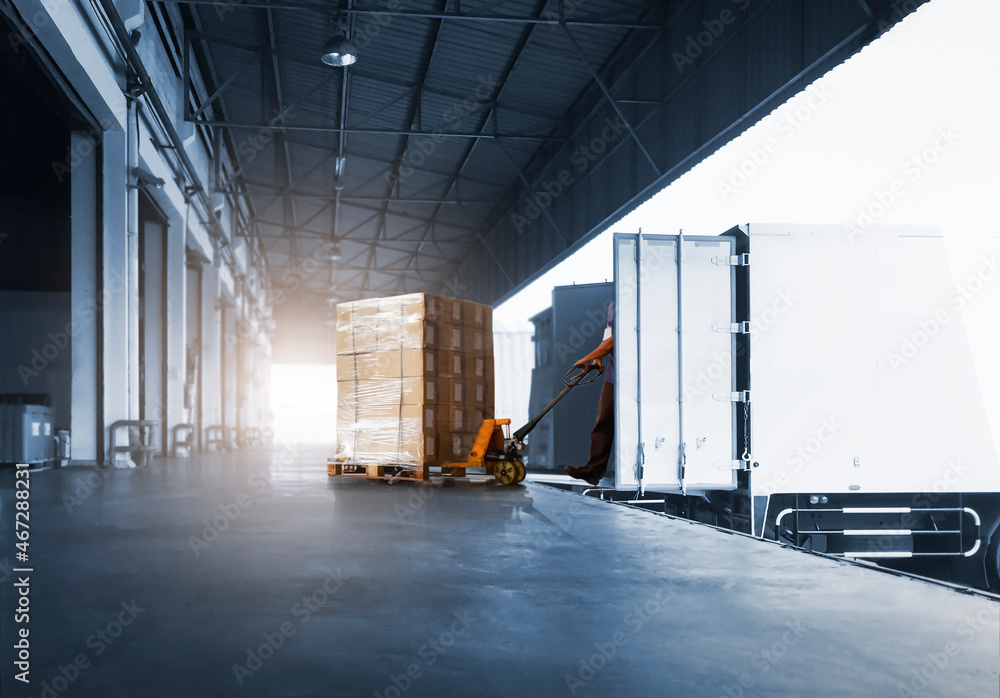Worker Courier Unloading Package Boxes into Cargo Container. Delivery service. Truck Loading at Dock Warehouse. Shipments Supply Chain. Shipping Warehouse Logistics Transportation. Worker Courier Unloading Package Boxes into Cargo Container. Delivery service. Truck Loading at Dock Warehouse. Shipments Supply Chain. Shipping Warehouse Logistics Transportation.