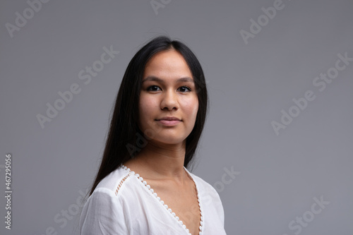 Portrait of a young woman with long straight dark hair