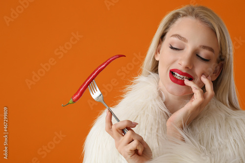 Sexy young woman with chili...