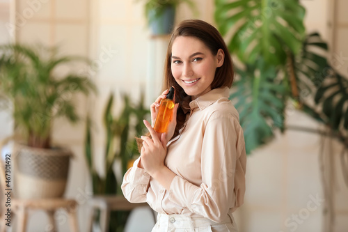Happy young woman with bott...