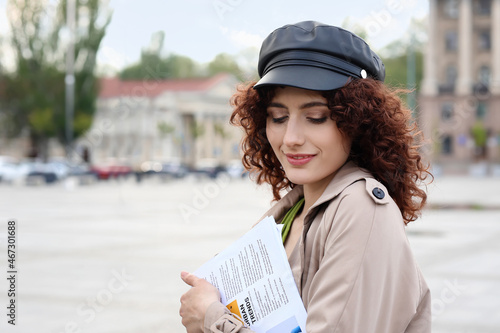 Young woman in leather hat ...