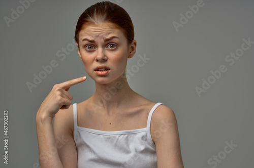 woman in white t-shirt toothache health problems disorder studio treatment