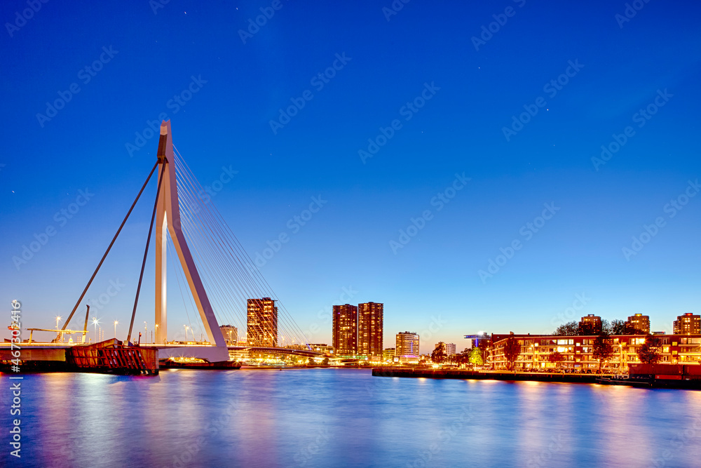Night View of Renowned Erasmusbrug (Swan Bridge) in  Rotterdam in Front of Port with Harbour. Shoot Made At Dusk.