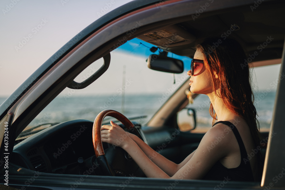 pretty woman in sunglasses driving a car trip