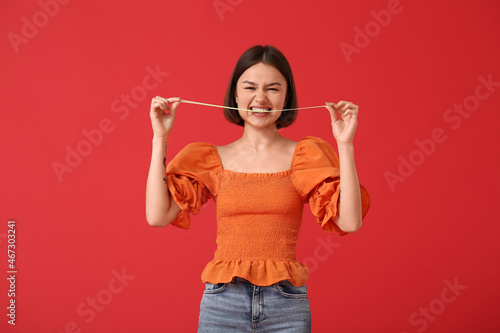Funny young woman with chew...