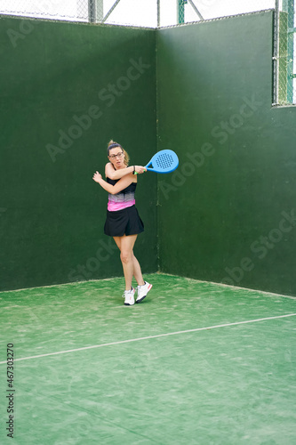 Sportswoman during padel training in gym © JoseIMartin