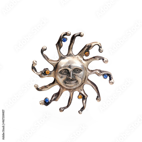 Silver brooch sun with colored gemstones isolated on white background